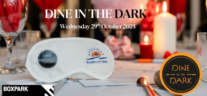 Image shows table laid for an evening meal with cutlery, glasses and a candle in the background. White eye mask with Bradbury and Dine in the Dark logo. Black BOXPARK logo in bottome left.