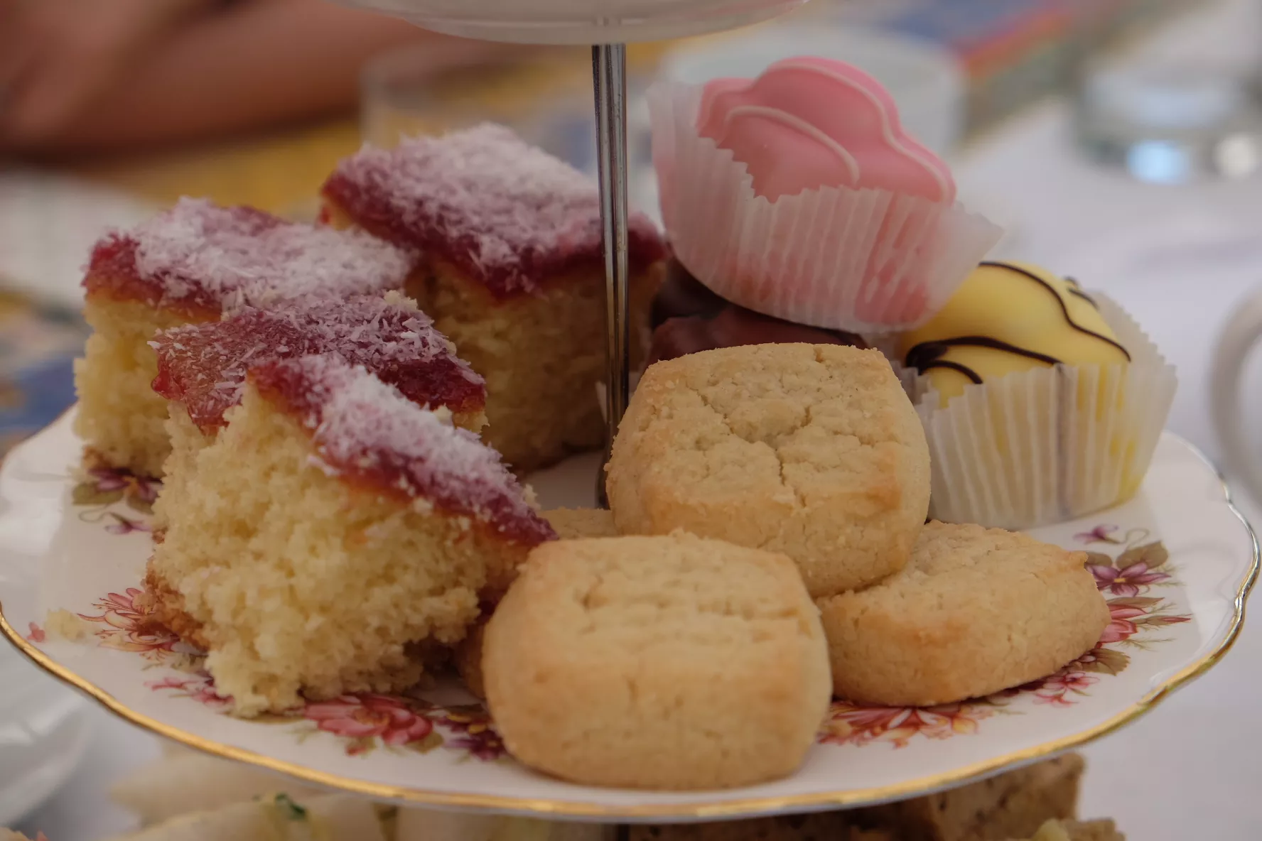 http://A%20close-up%20of%20a%20selection%20of%20afternoon%20tea%20cakes.%20We%20can%20see%20mini%20round%20shortbreads,%20small%20squares%20of%20jam%20and%20coconut%20sponge%20and%20some%20fondant%20fancies.